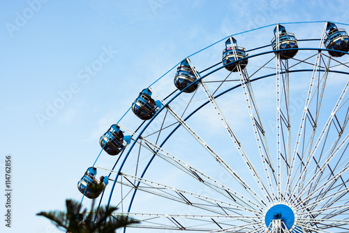 abstract background of ferris wheel at the fun park with blue sky on background with vintage tone  photo