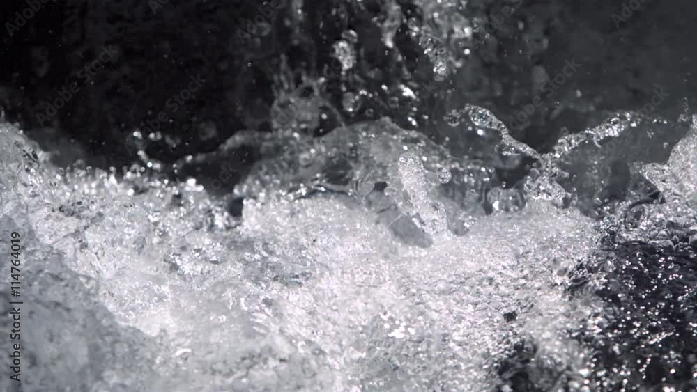 Ultra-slow motion water splashing at the foot of a falls Ultra-slow motion water splashing at the foot of a falls