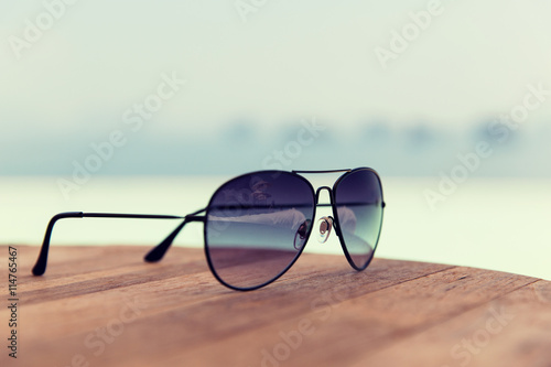 shades or sunglasses on table at beach