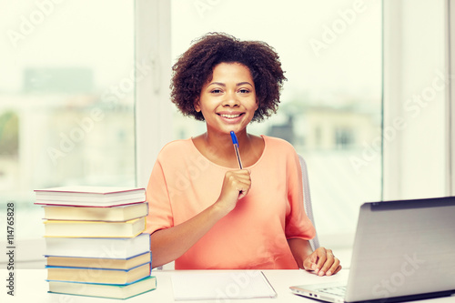 happy african american woman with laptop at home