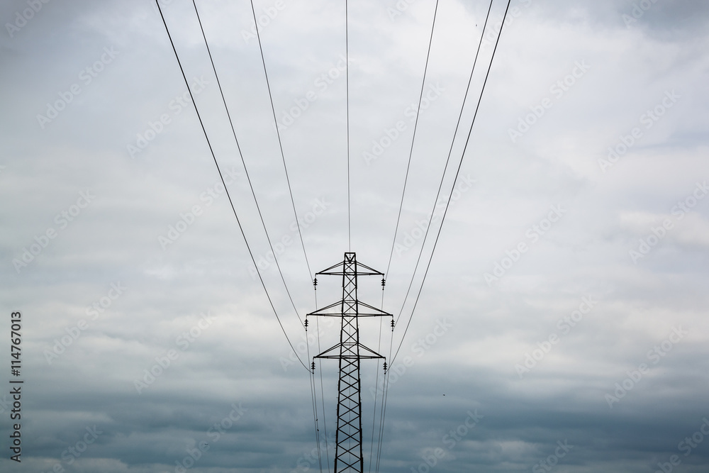 Under the power cables and tower on overcast day in UK Under the power cables and tower on overcast day in UK