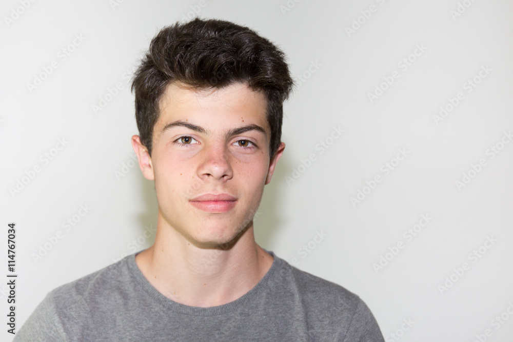 Confident teenage boy smiling isolated on white Confident teenage boy smiling isolated on white