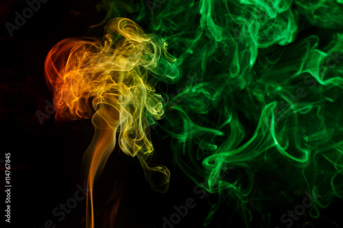 Abstract yellow green smoke from aromatic sticks.