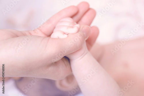 Child hand holding parent hand, closeup © Africa Studio