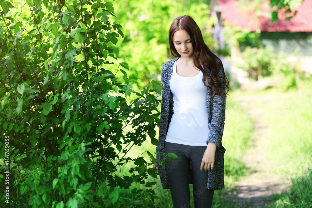 Young beautiful girl walking in park