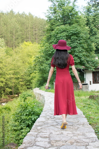 Woman walking the path wearing red dress