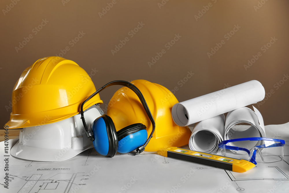 Construction plans and builder equipment on table Construction plans and builder equipment on table