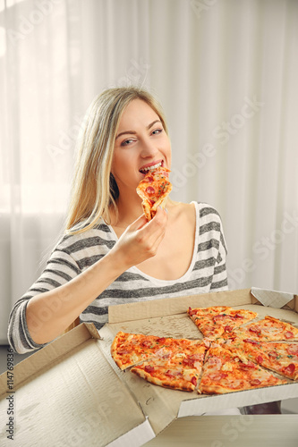 Beautiful woman eating pizza