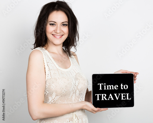 technology, internet and networking - close-up successful woman holding a tablet pc with time to travel sign. internet technology in tourism