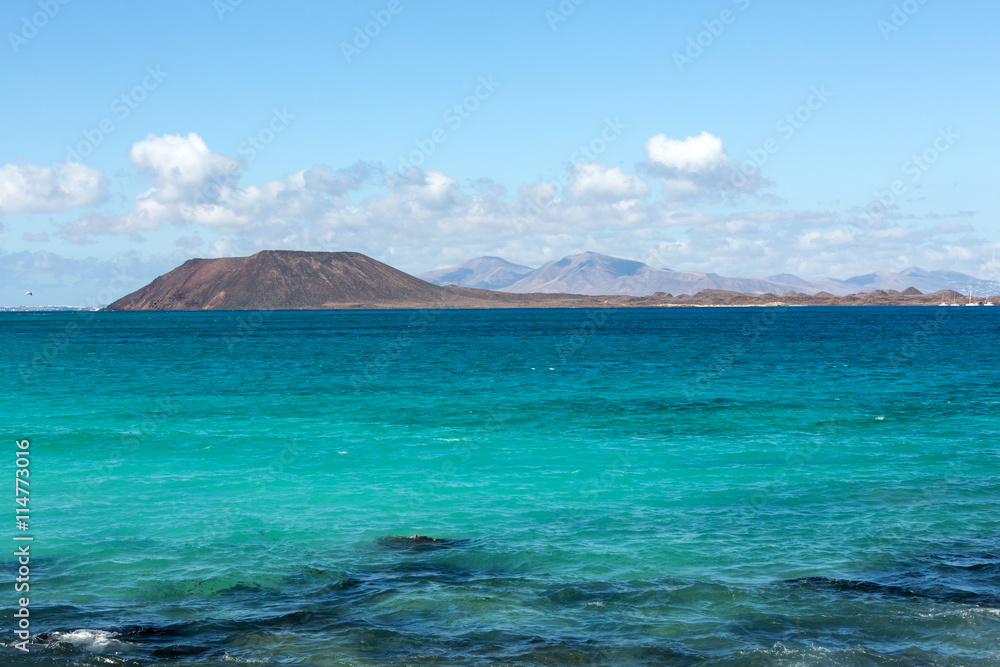 View of Lobos island from Beach in Corralejo, Fuerteventura, Canary Islands, Spain View of Lobos island from Beach in Corralejo, Fuerteventura, Canary Islands, Spain