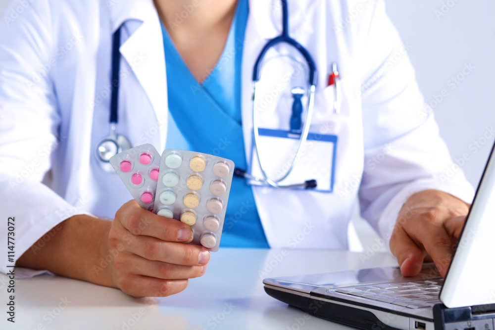 the doctor writes a prescription pill on the computer the doctor writes a prescription pill on the computer
