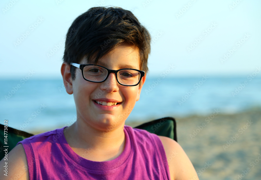 boy with glasses smiling on the sea shore boy with glasses smiling on the sea shore