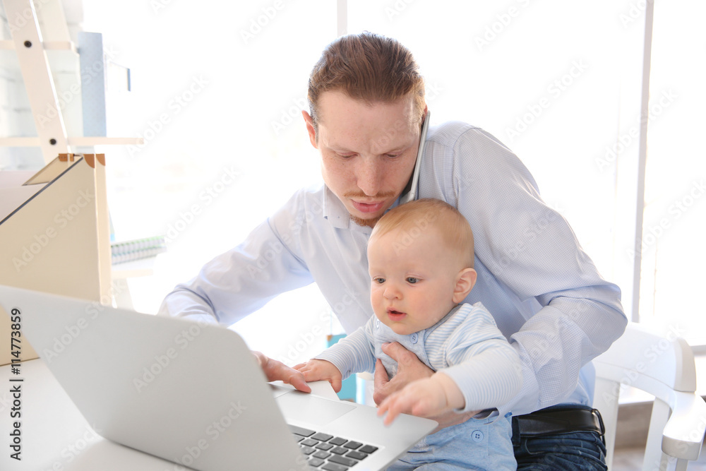 Young father with his little son working at home Young father with his little son working at home