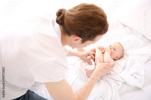 Father changing diaper to h...