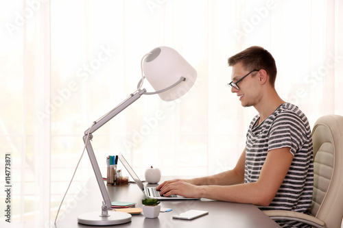 Man working at computer at ...