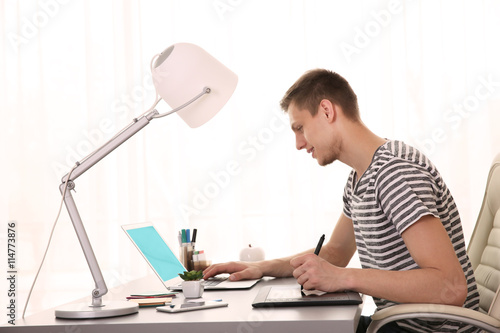 Man working at computer at ...