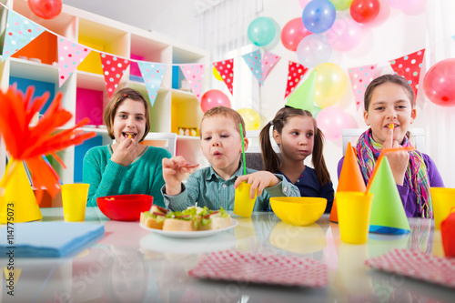 Group of adorable kids having fun at birthday party