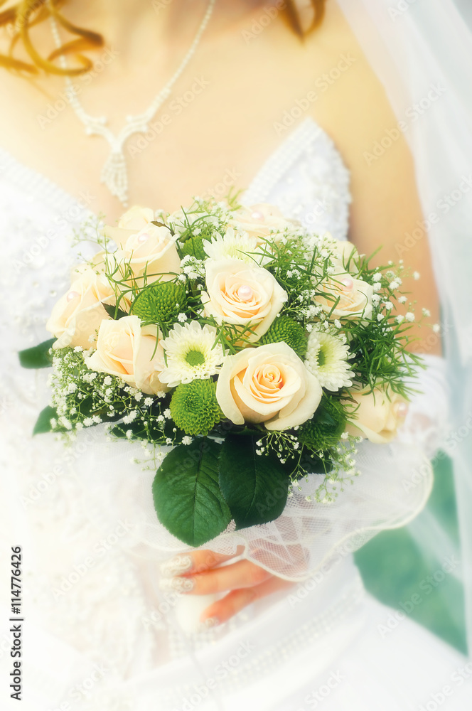 Beautiful wedding bouquet of flowers in hands of the bride Beautiful wedding bouquet of flowers in hands of the bride
