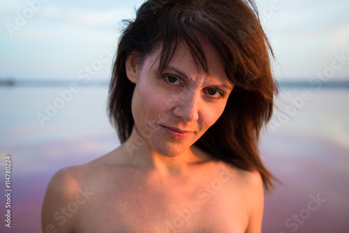 Pretty woman in a colorful lake