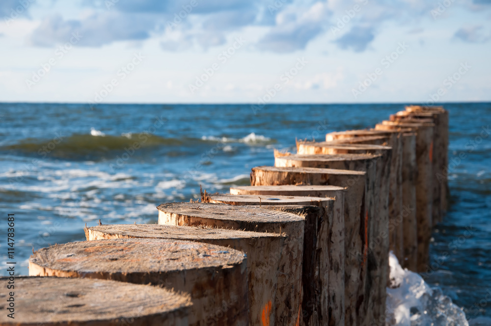 Breakwater on sea and blue sky