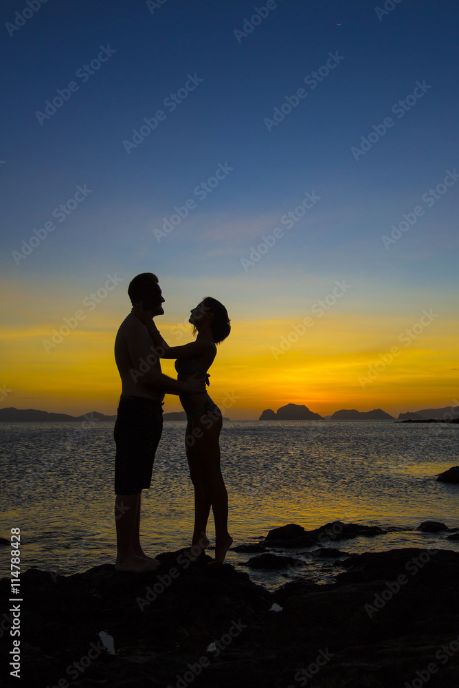 Silhouettes loving couple at sunset on the Philippine Islands Silhouettes loving couple at sunset on the Philippine Islands