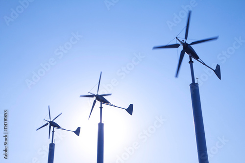 Energy wind turbines on clear blue sky