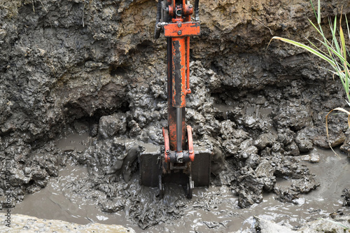 Mini excavator with excavation work for a new pond