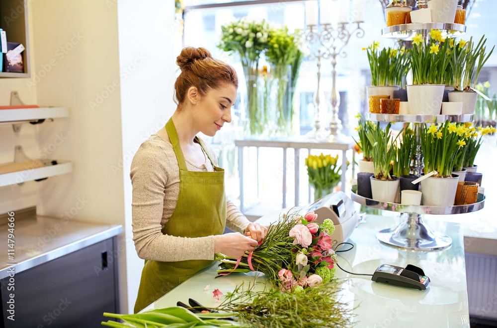 smiling florist woman making bunch at flower shop smiling florist woman making bunch at flower shop