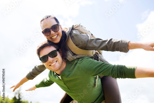 happy couple with backpacks having fun outdoors