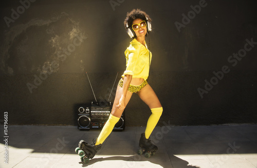 a cool roller skating woman dances and skates outside in an urban setting