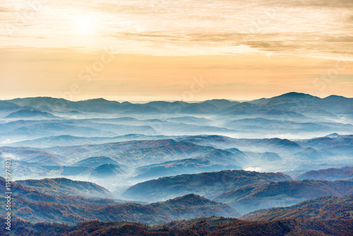 Ranges of blue mountains at sunset