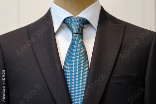 Black business suit with a white shirt and with a blue tie in drawing