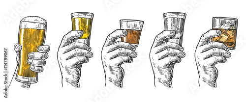 Male hand holding a glasses with beer, tequila, vodka, rum, whiskey and ice cubes. photo