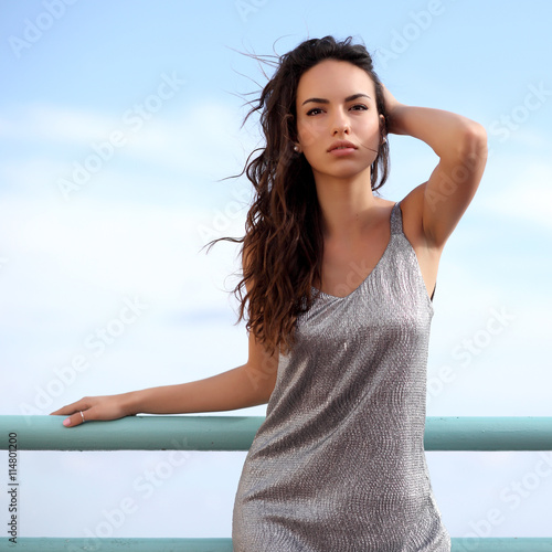 Beautiful young woman outdoors portrait near the sea photo