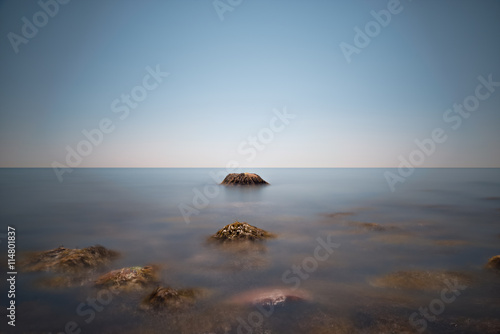 Rock formation, partially covered by sea