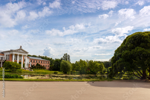 The building is of pink brick with white columns on the shore of the pond. The main Botanical garden. Moscow. 