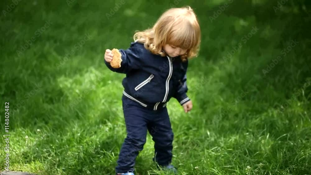 active child jumping with cookies from the curb in the park active child jumping with cookies from the curb in the park