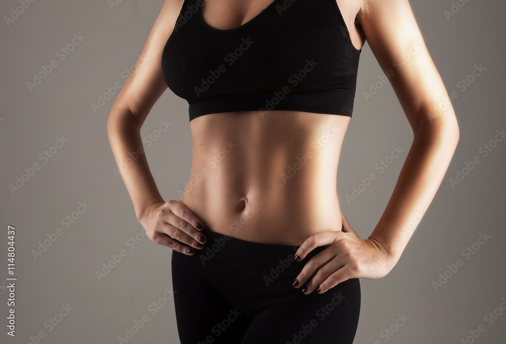 Fototapeta premium Athlete showing perfect slim stomach