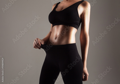 Athlete showing her slim stomach