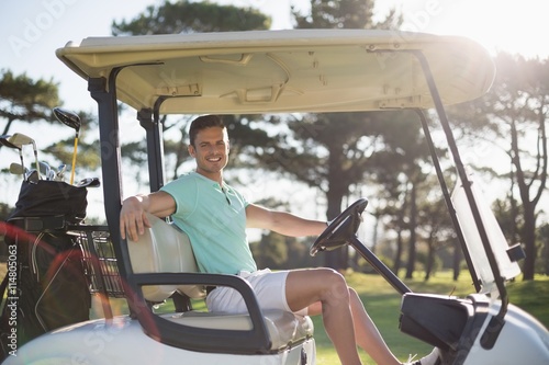 Portrait of smart man sitting in golf buggy