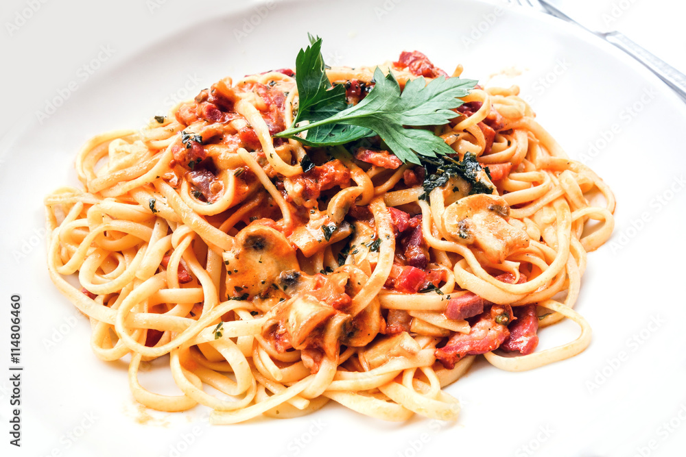 close-up of plate of pasta and chicken with lettuce