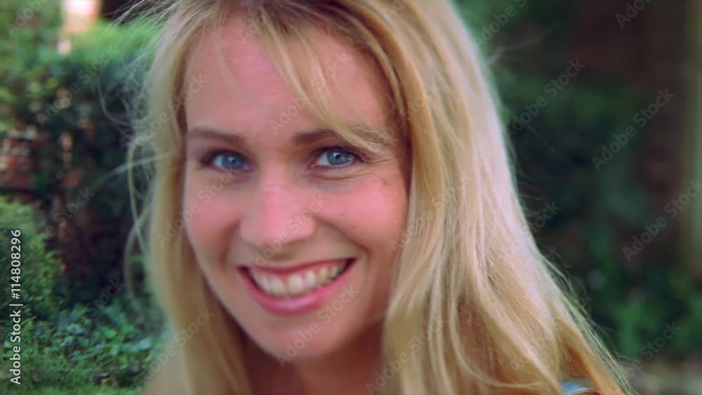 Close-up profile of blonde-haired young woman smiling Close-up profile of blonde-haired young woman smiling