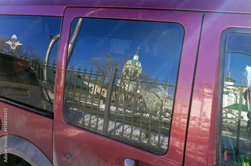 Reflection of the  belfry  in car window.