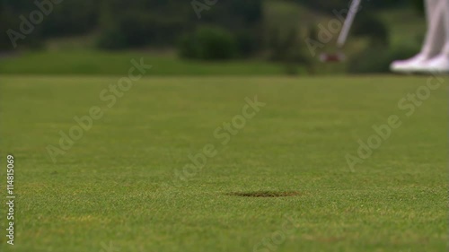 Close-up of successful putt