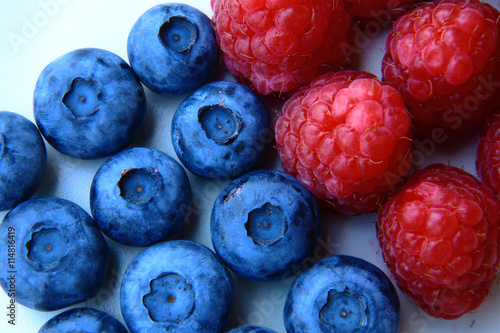 closeup of a bunch of raspberries and blueberries