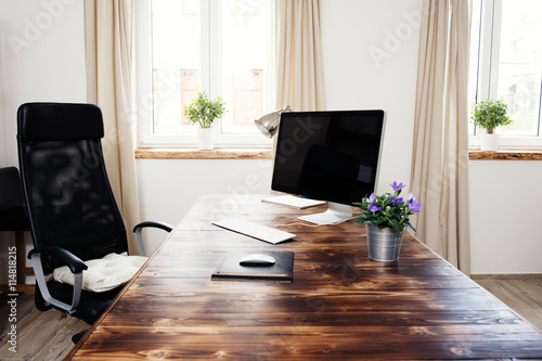 Home office with wooden table and computer