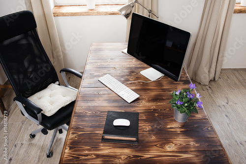 Home office with wooden table and computer
