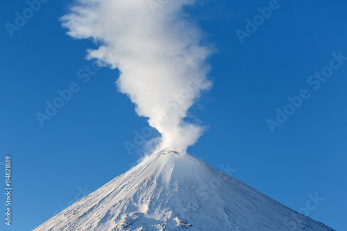 Landscape of Kamchatka: active Klyuchevskoy Volcano, view of top of a volcanic eruption: emission from crater of volcano plume of gas, steam, ashes. Kamchatsky Region, Klyuchevskaya Group of Volcanoes