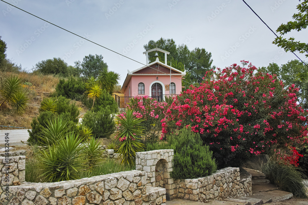 Naklejka premium Orthodox church with spring flowers, Kefalonia, Ionian islands, Greece