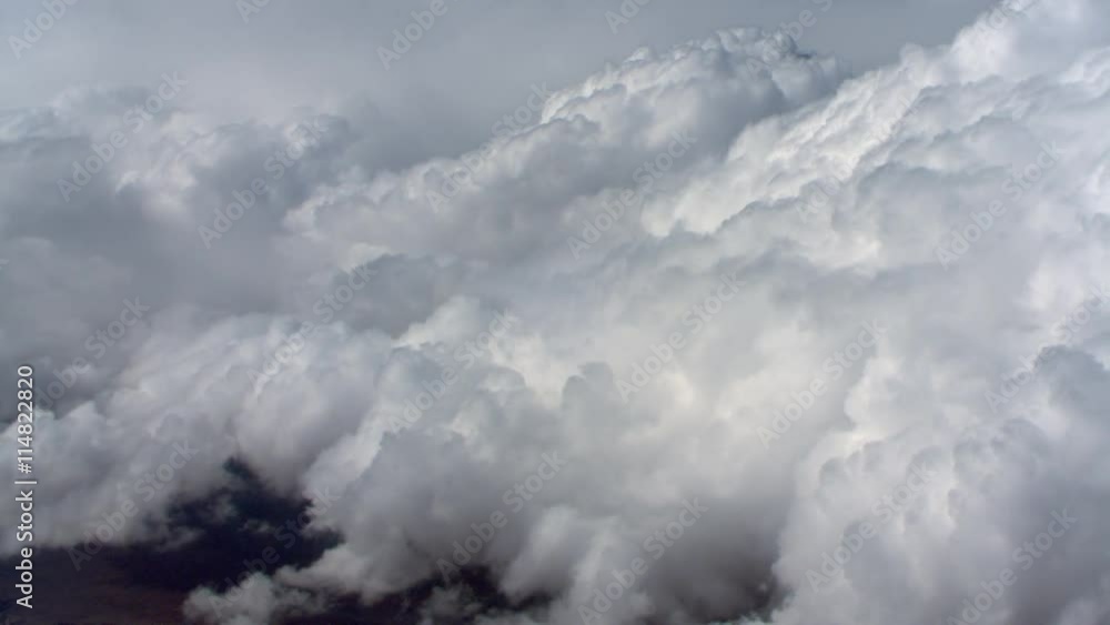 Climbing flight alongside cumulus clouds, passenger POV Climbing flight alongside cumulus clouds, passenger POV
